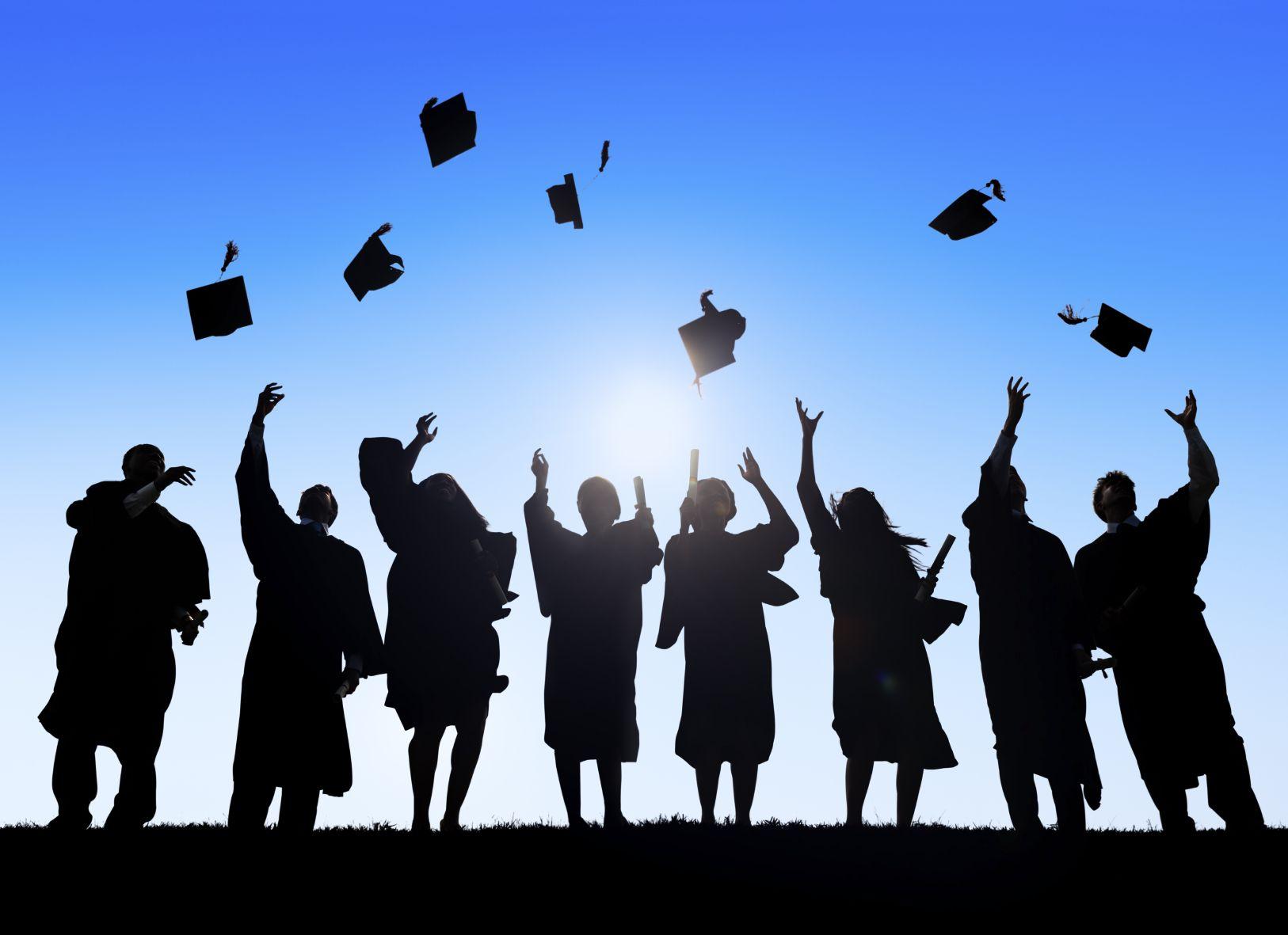 Graduates throwing their hats into the air